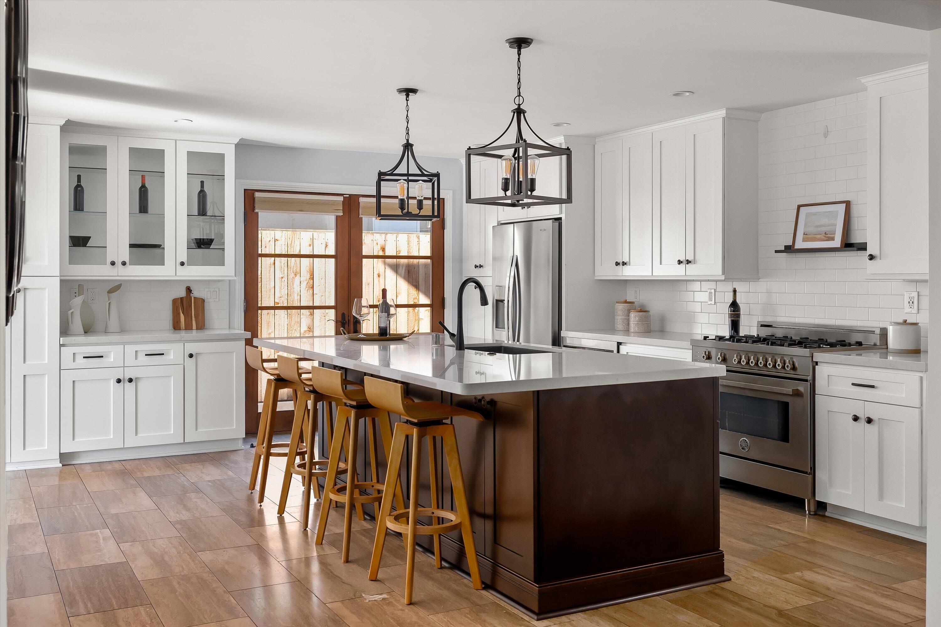 a kitchen with stainless steel appliances granite countertop a sink a stove and cabinets