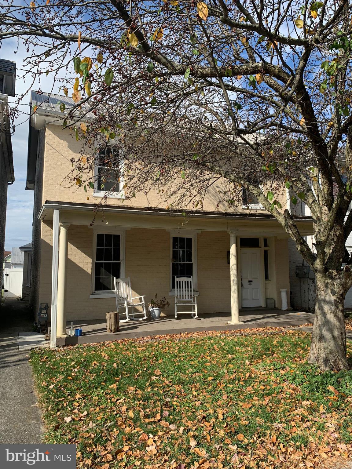 front view of a house with two trees