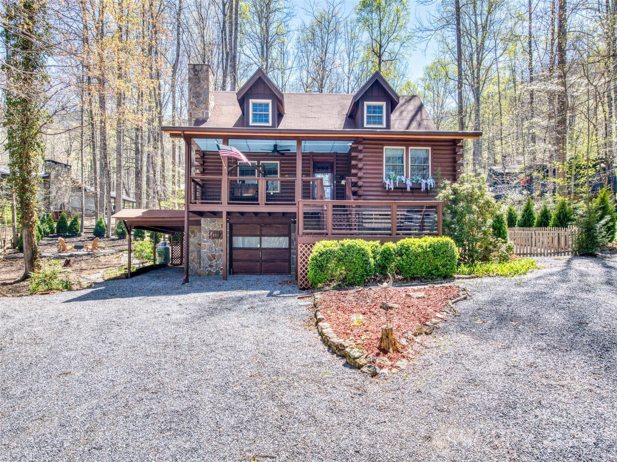 a view of a brick house with plants and wooden fence