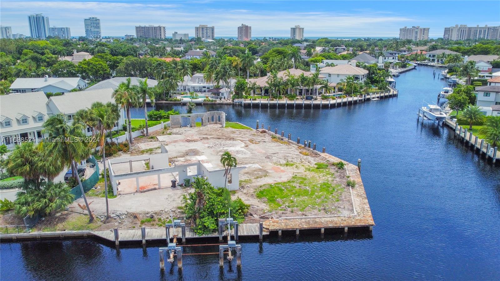 an aerial view of residential houses with outdoor space and lake view