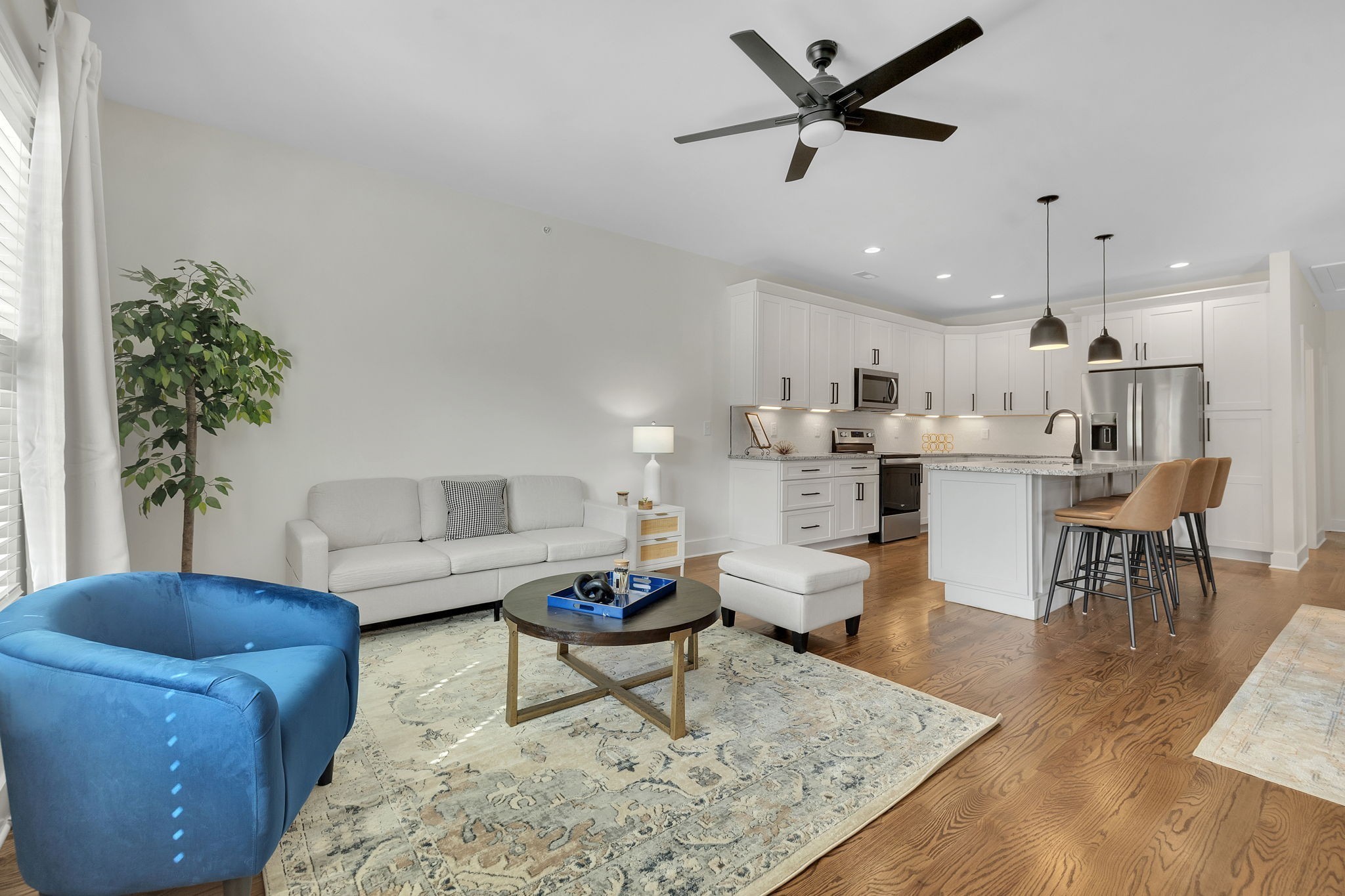 a living room with furniture and a dining table