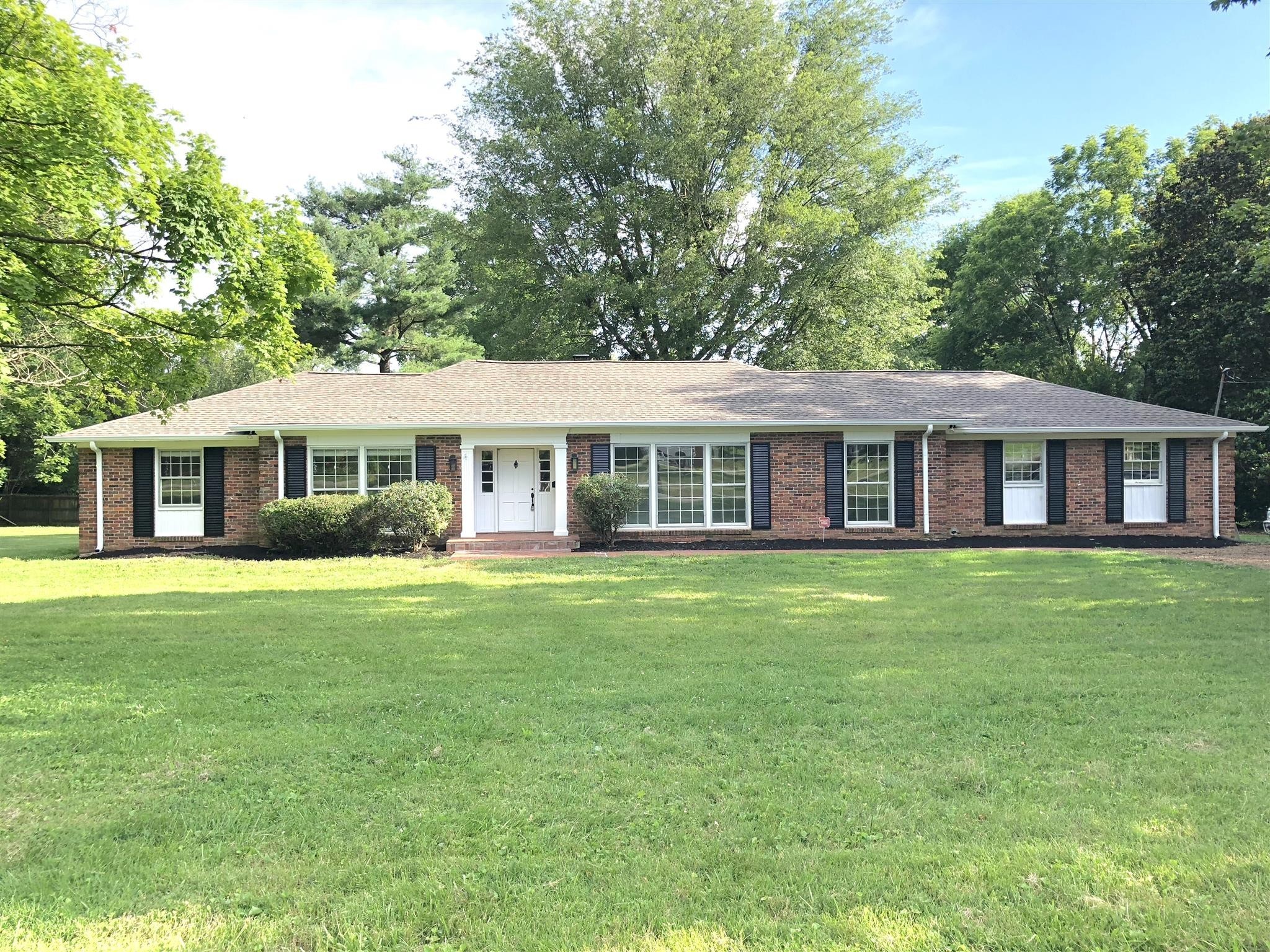 a front view of a house with a garden and porch