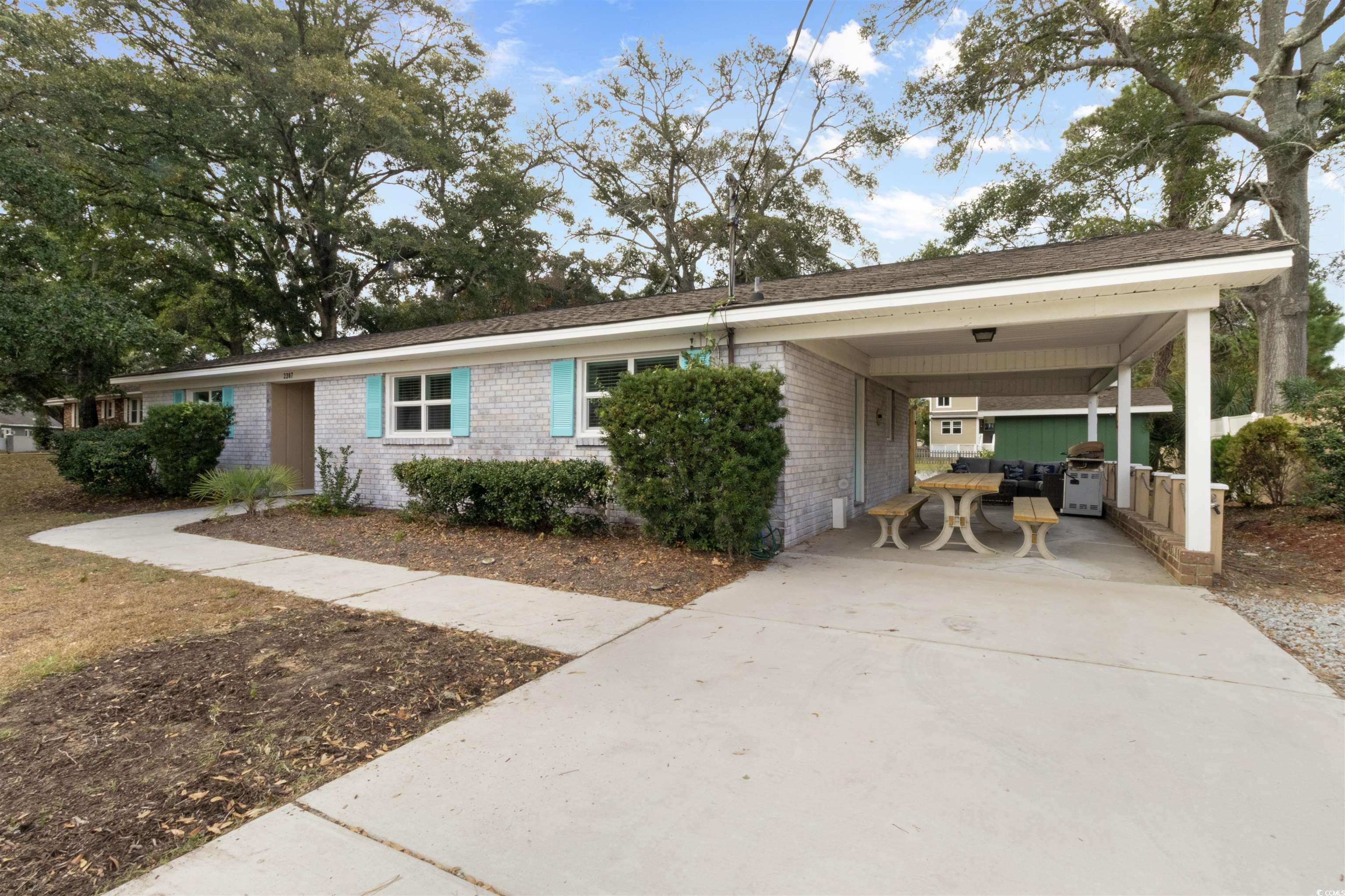 Ranch-style house featuring a carport