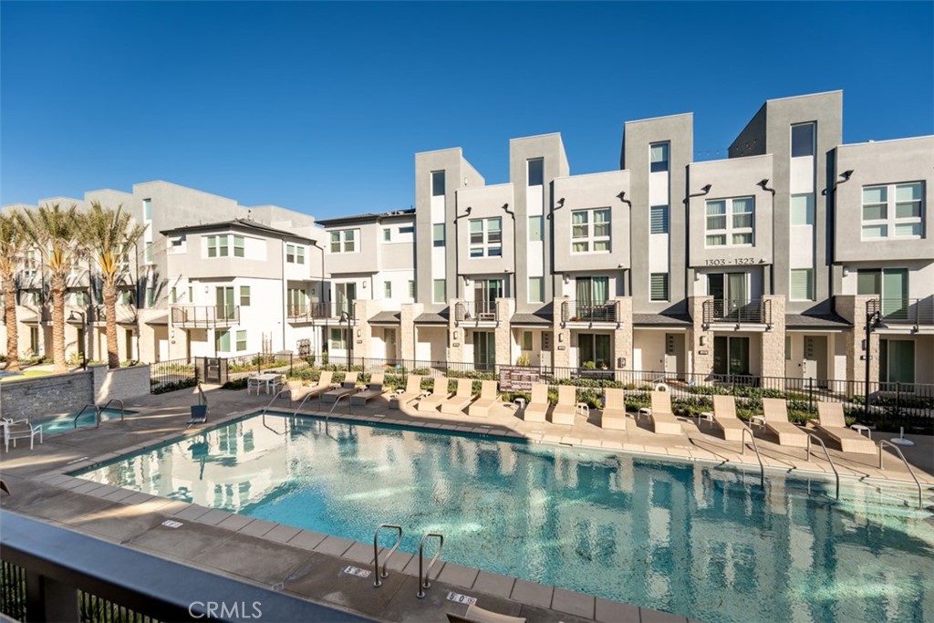 a view of a swimming pool with outdoor seating