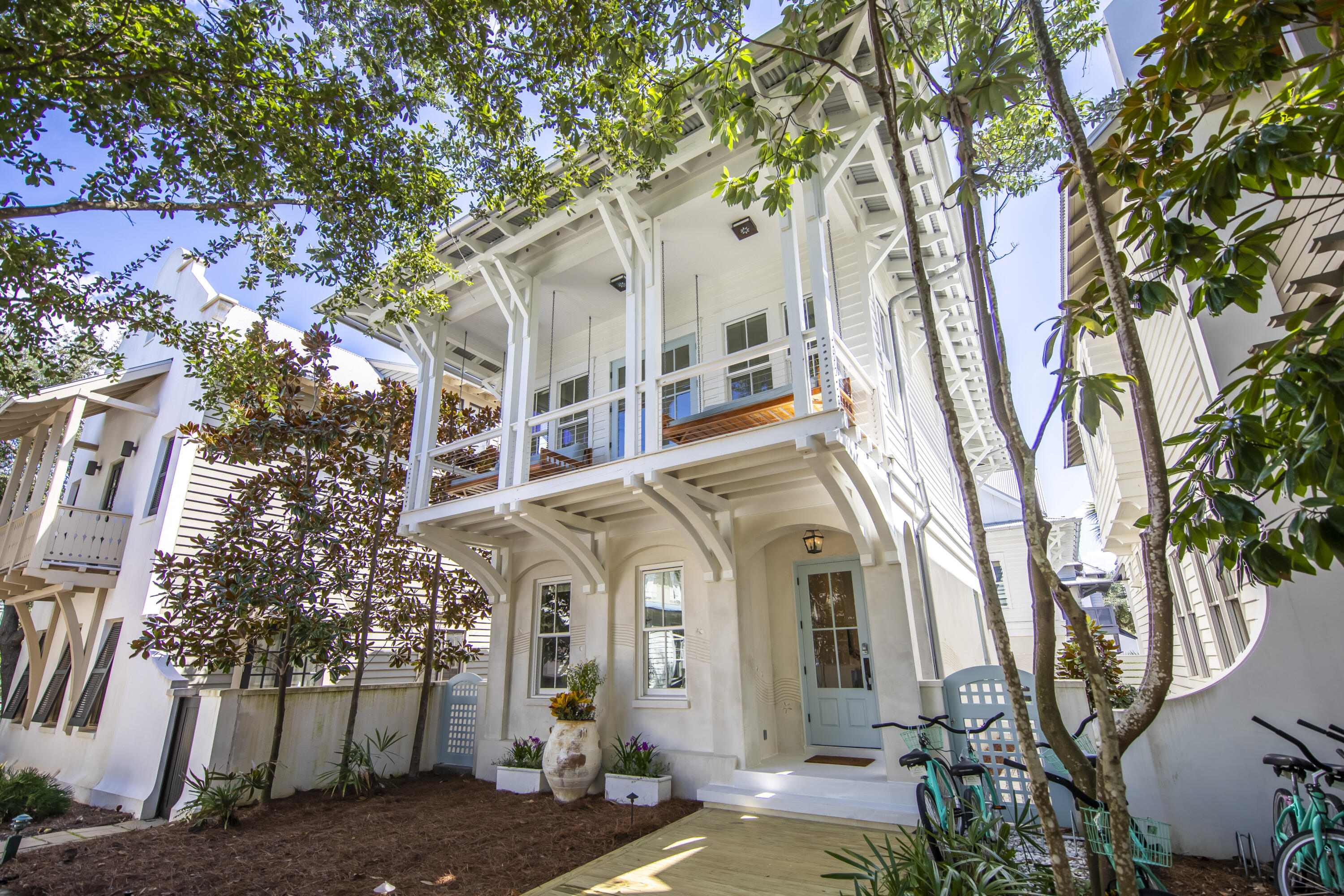 a front view of a house with a tree