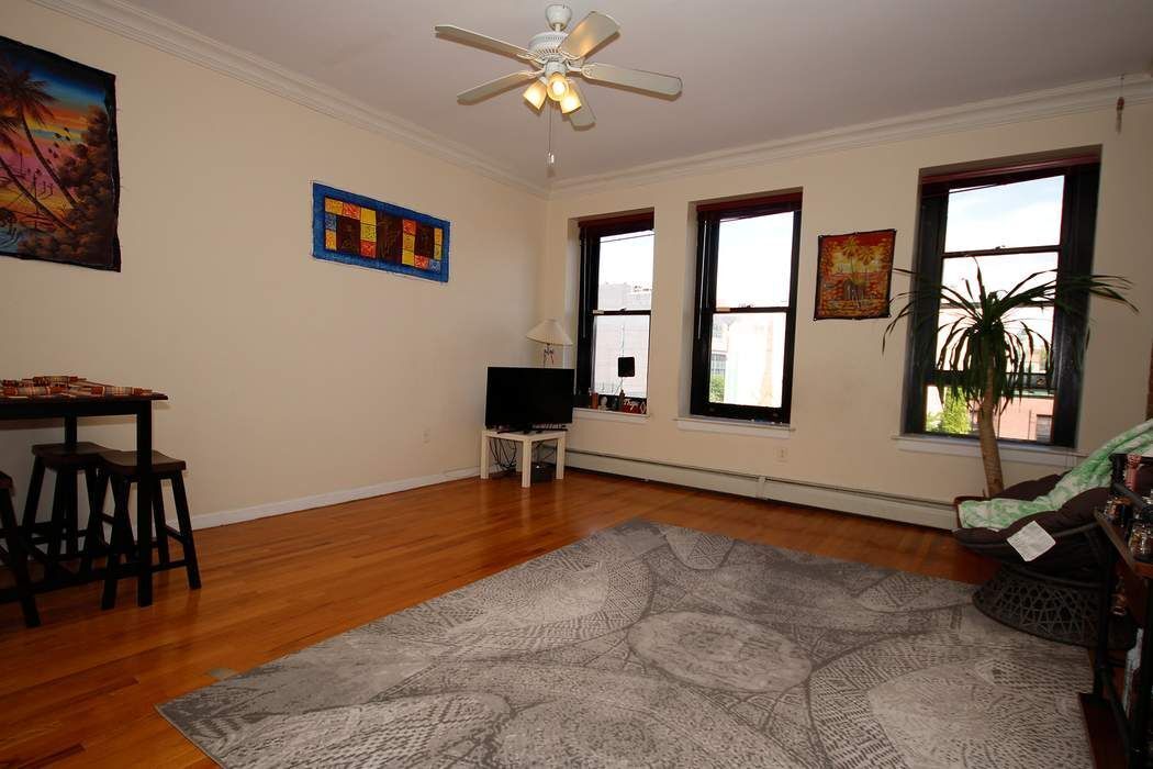 a view of a livingroom with furniture and a window