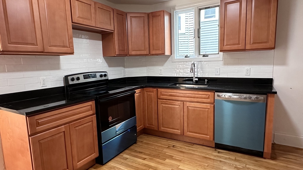 a kitchen with granite countertop a sink and cabinets