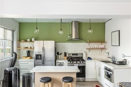 a kitchen with stainless steel appliances granite countertop a refrigerator and a stove