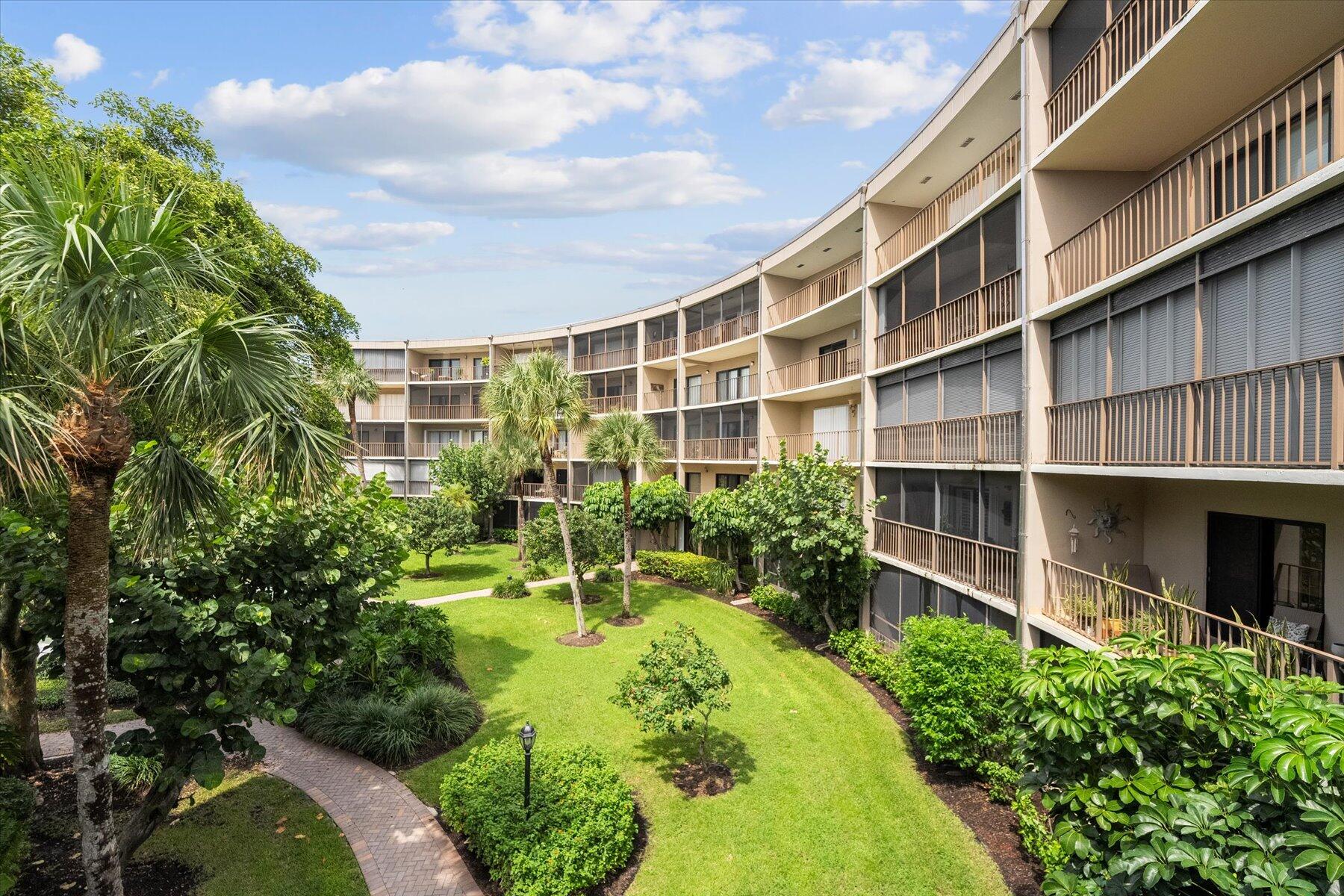 a backyard of a building with plants and garden