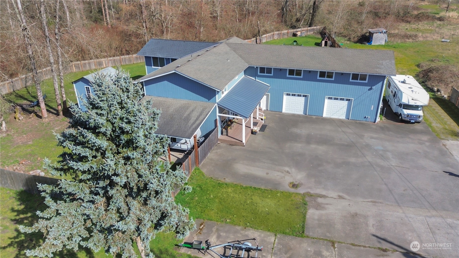 an aerial view of a house with a yard