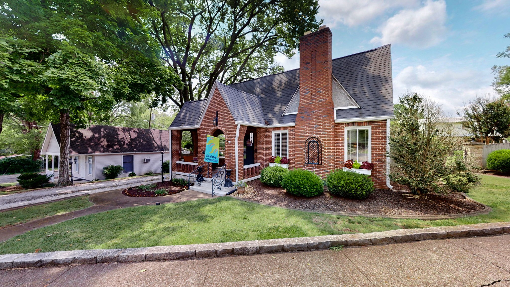 a view of a house with backyard porch and garden