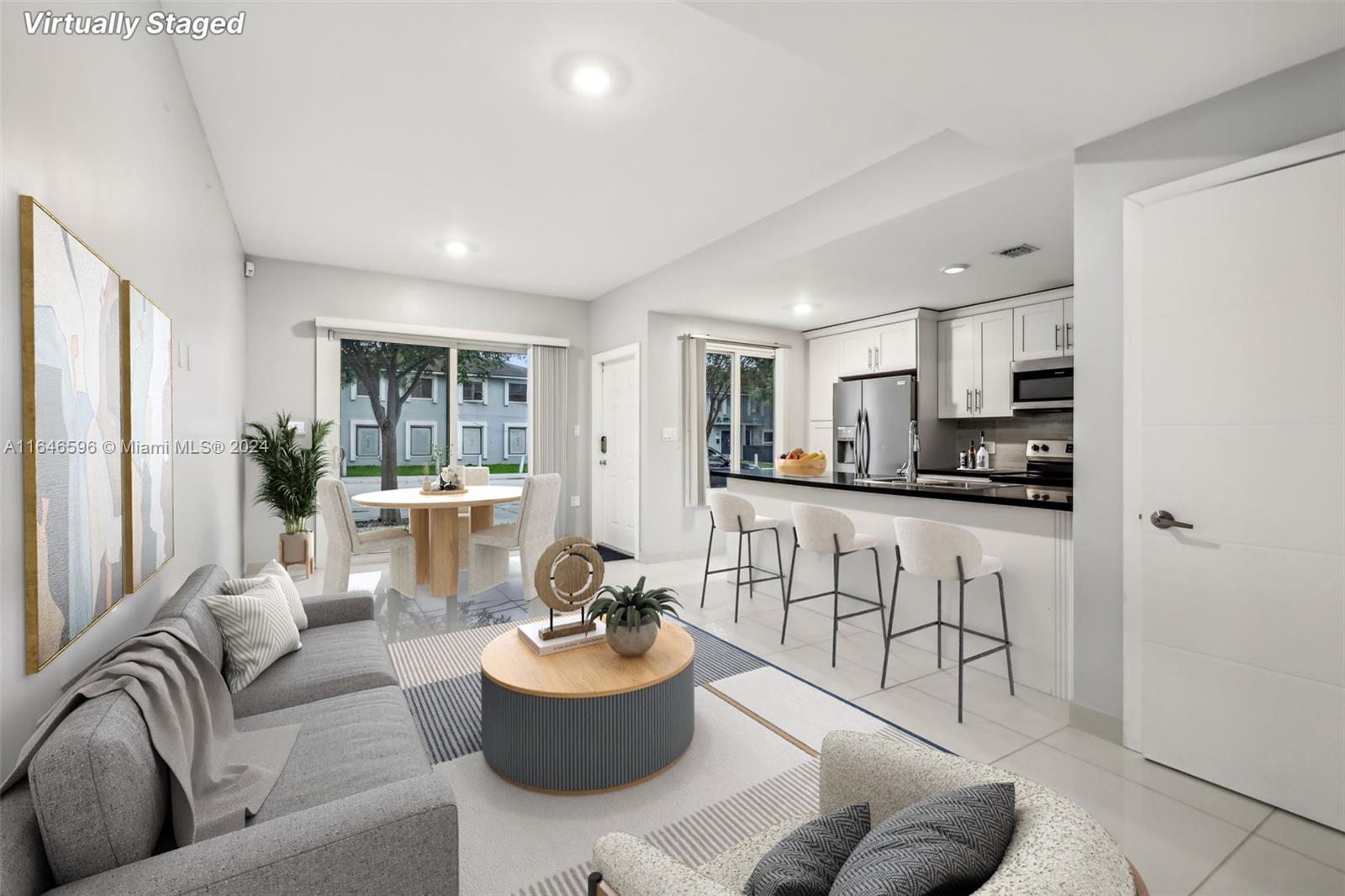 a living room with furniture and a view of kitchen