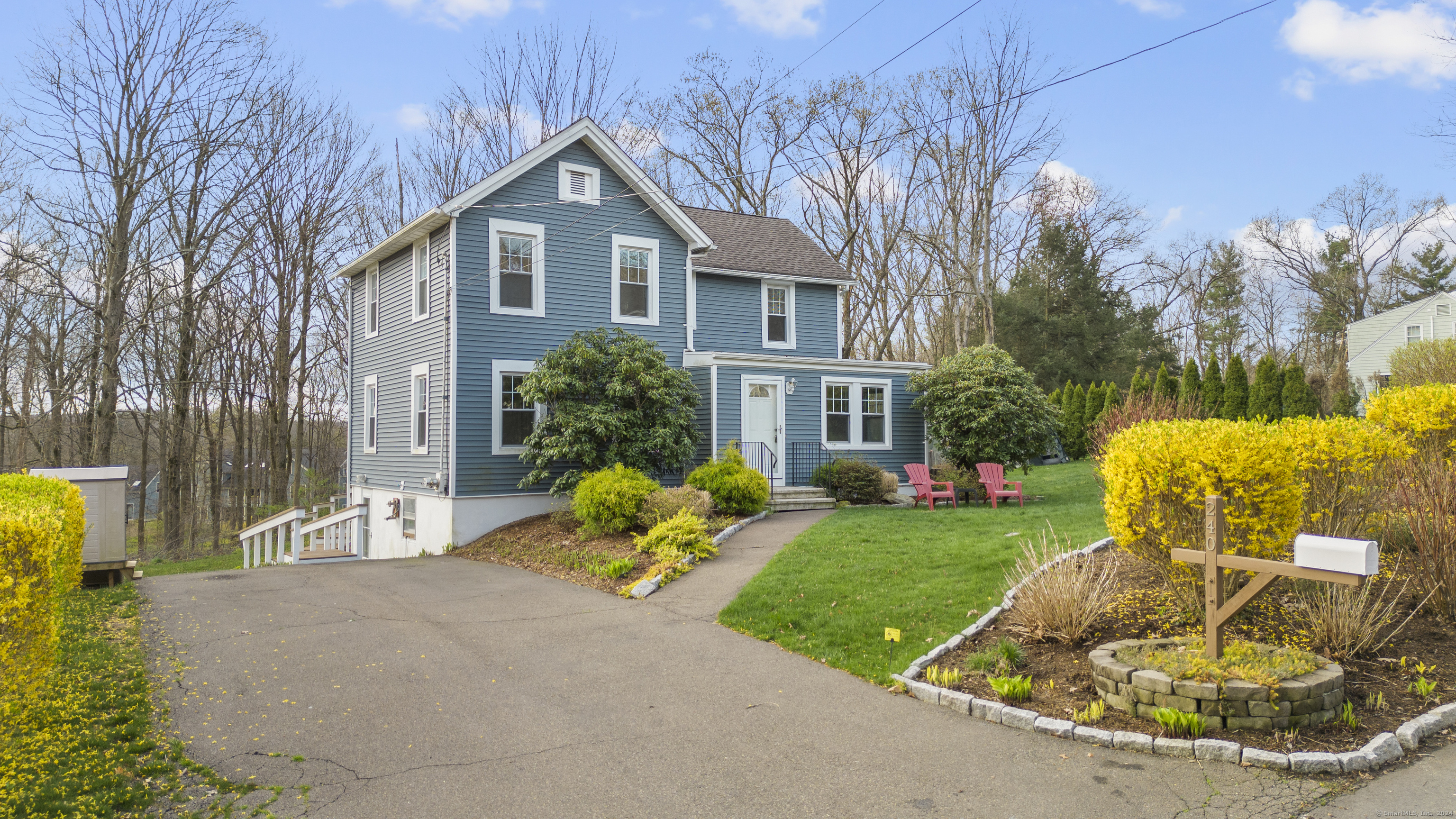 a front view of a house with a yard garage and outdoor seating