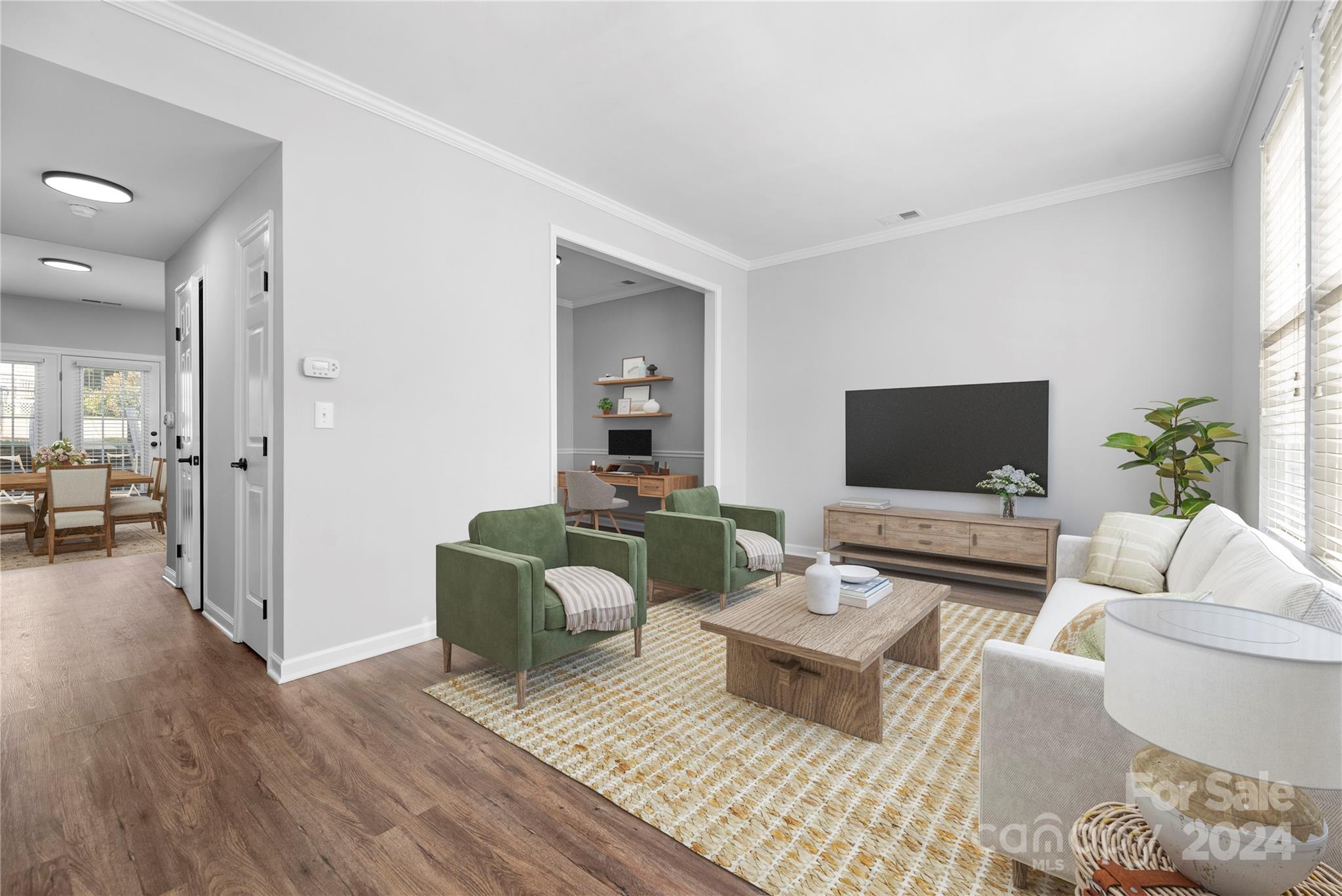 a living room with furniture and a flat screen tv