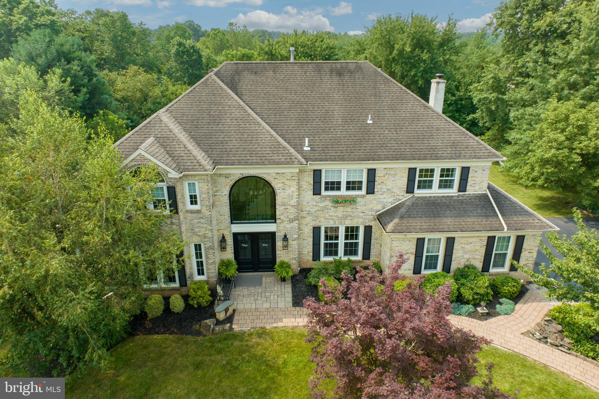 a aerial view of a house next to a yard