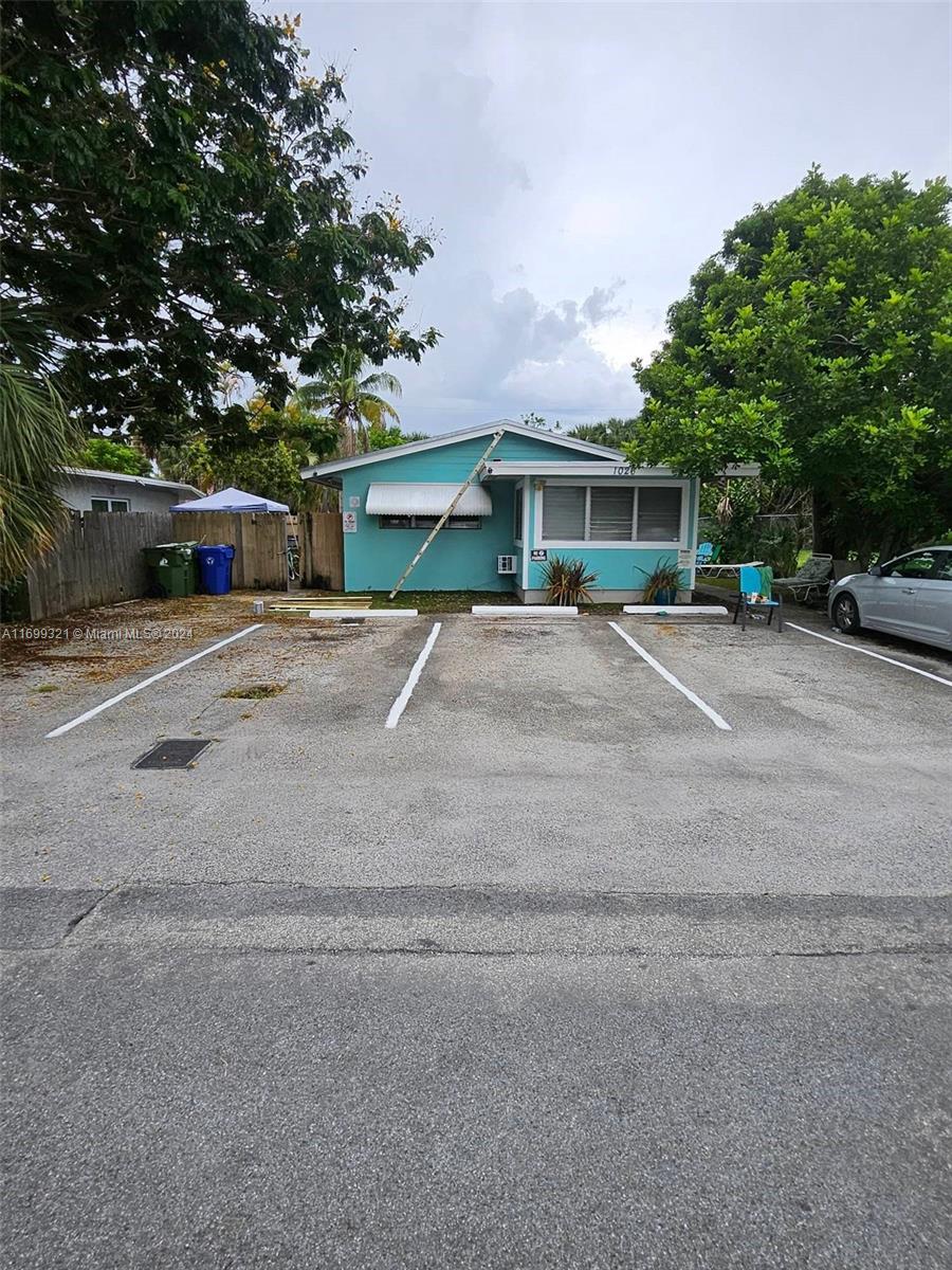 a front view of house with yard and trees