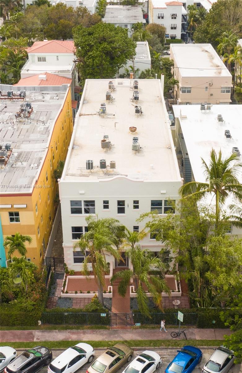 an aerial view of residential houses with yard