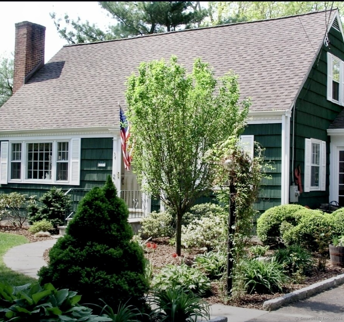 a aerial view of a house with a yard and potted plants