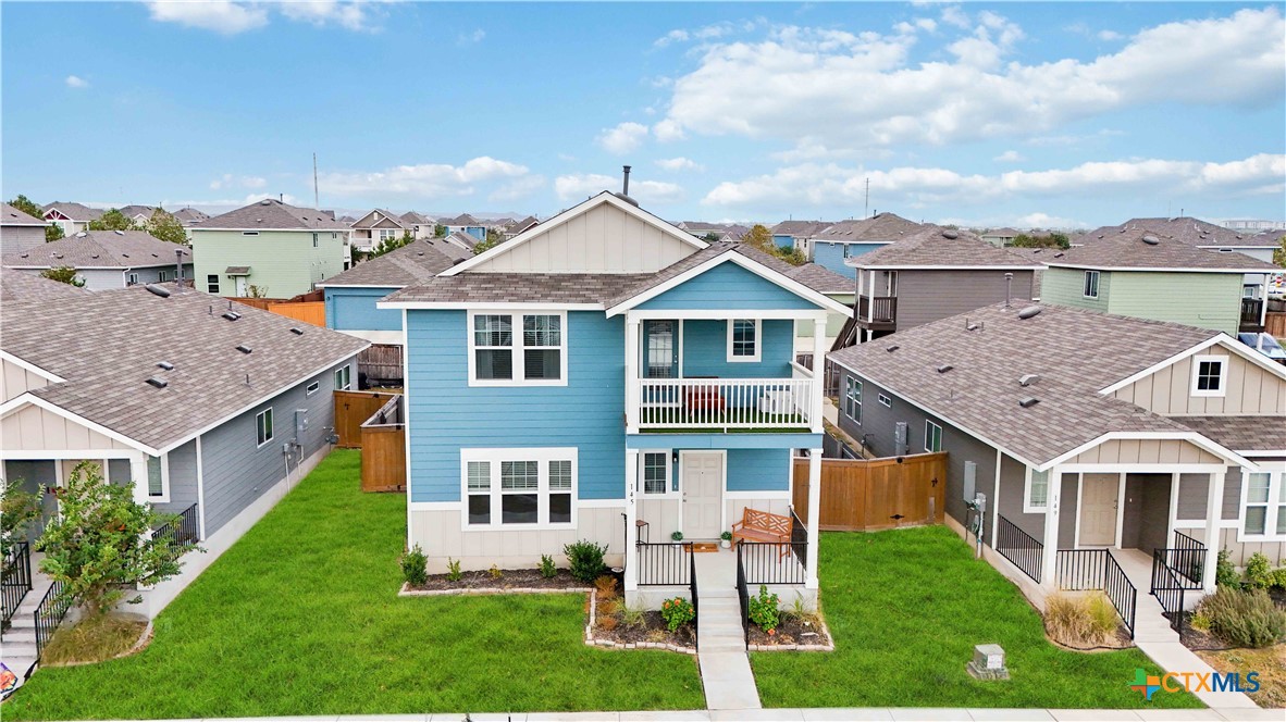 a aerial view of a house with a yard and table