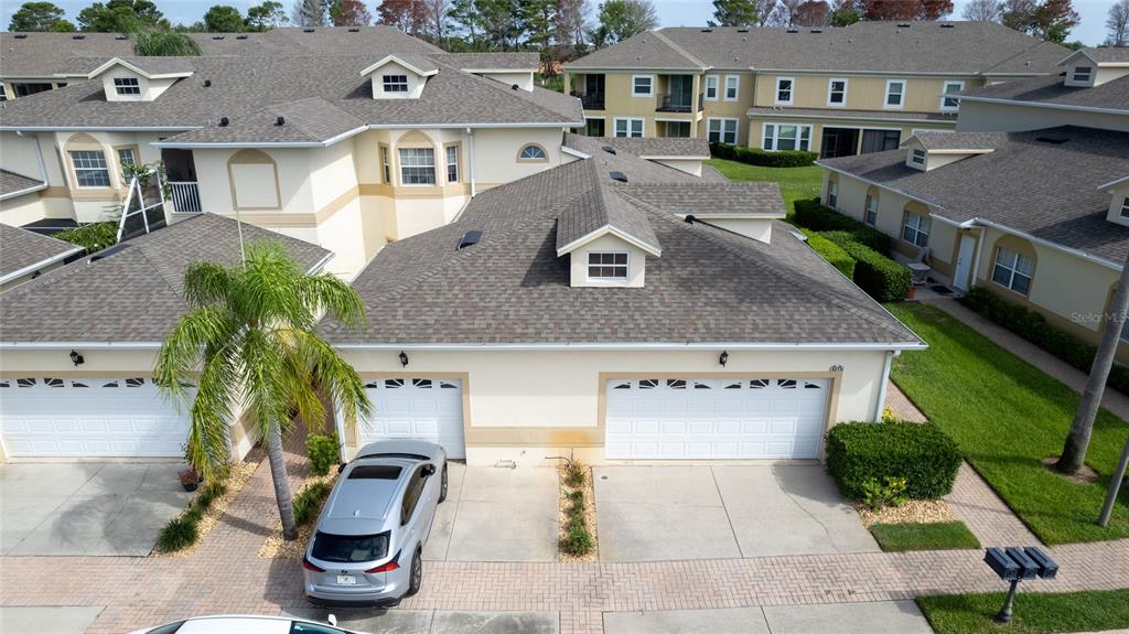 an aerial view of multiple houses with a yard