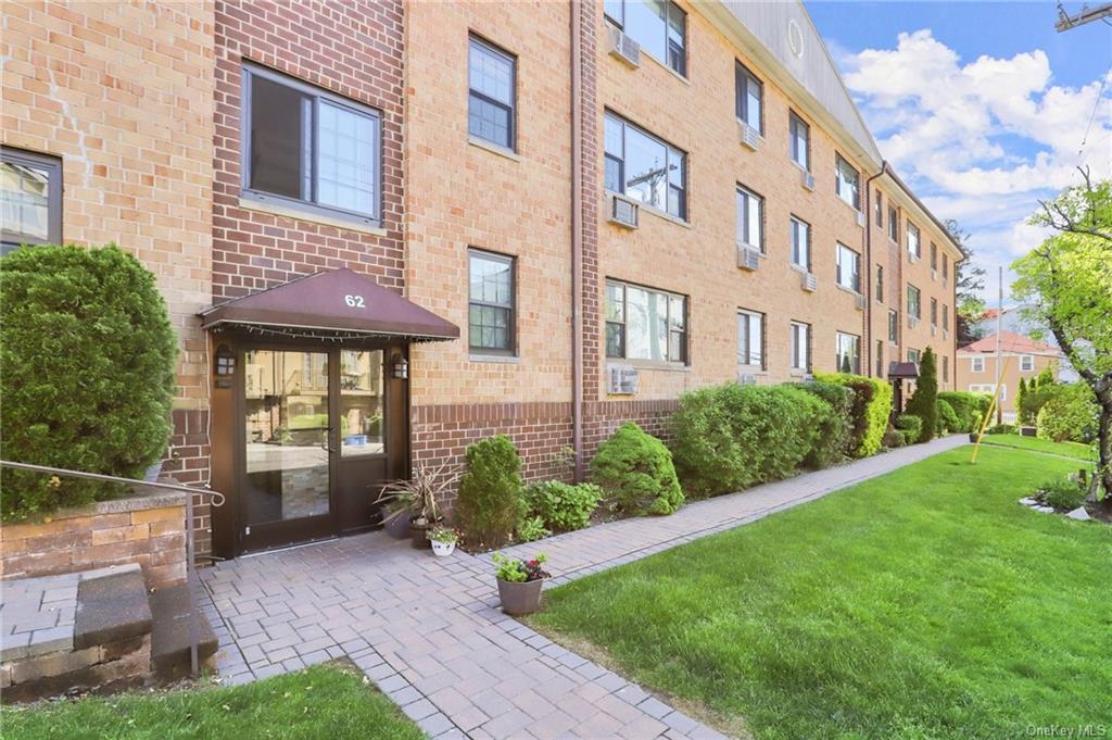 a view of a brick building next to a yard