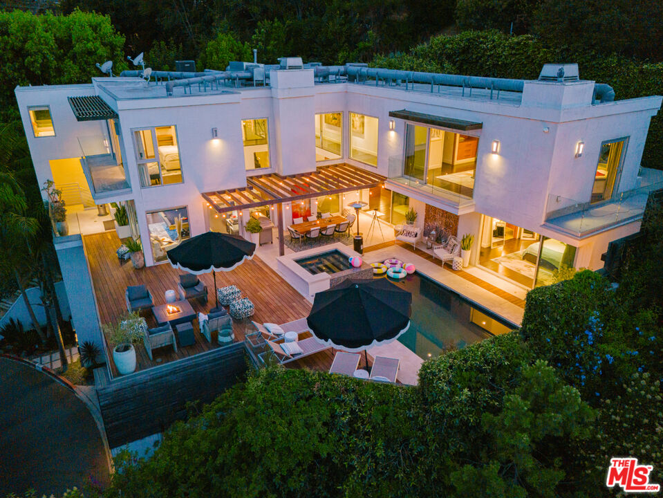 an aerial view of a house with a swimming pool