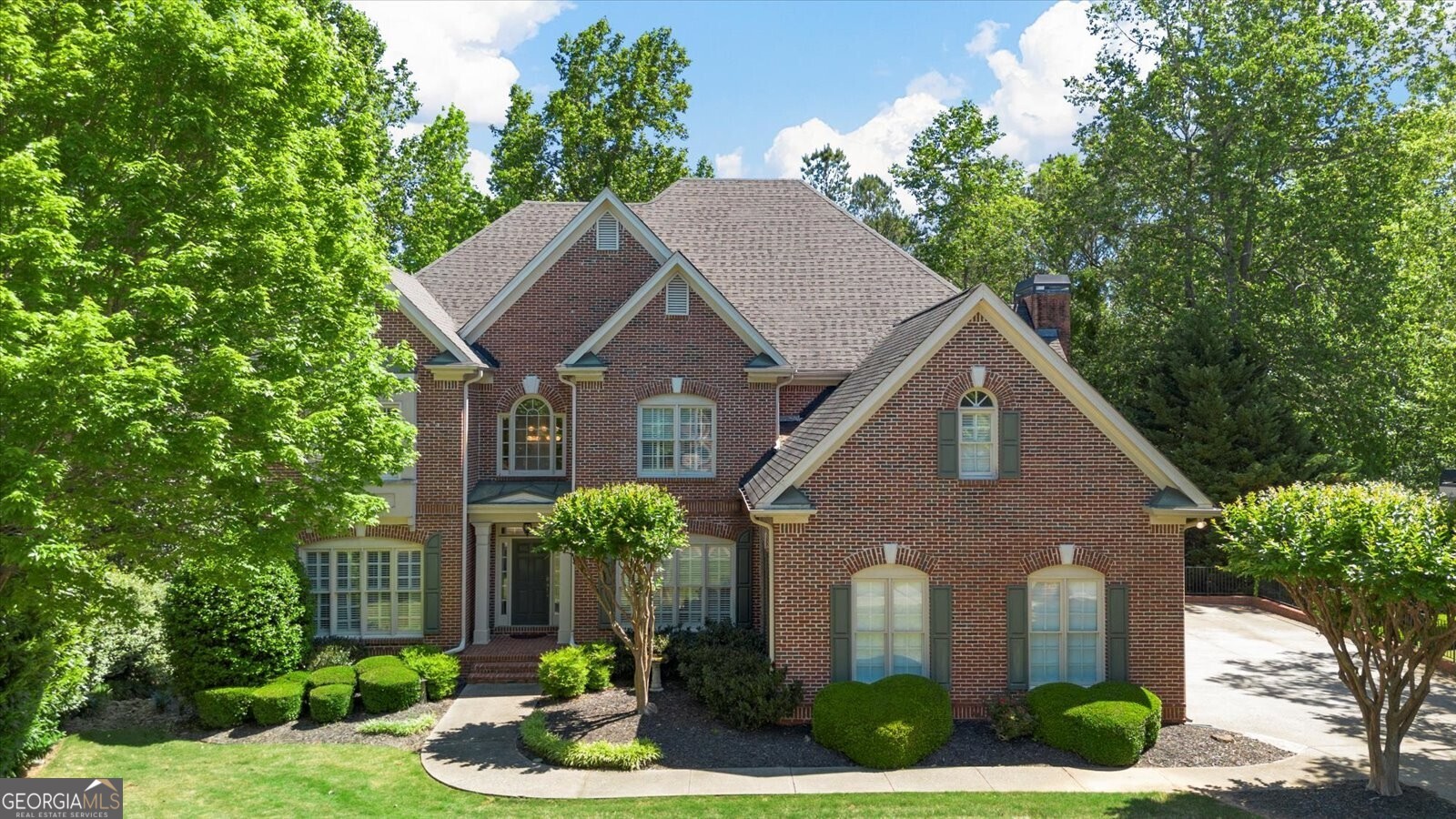 a front view of a house with garden