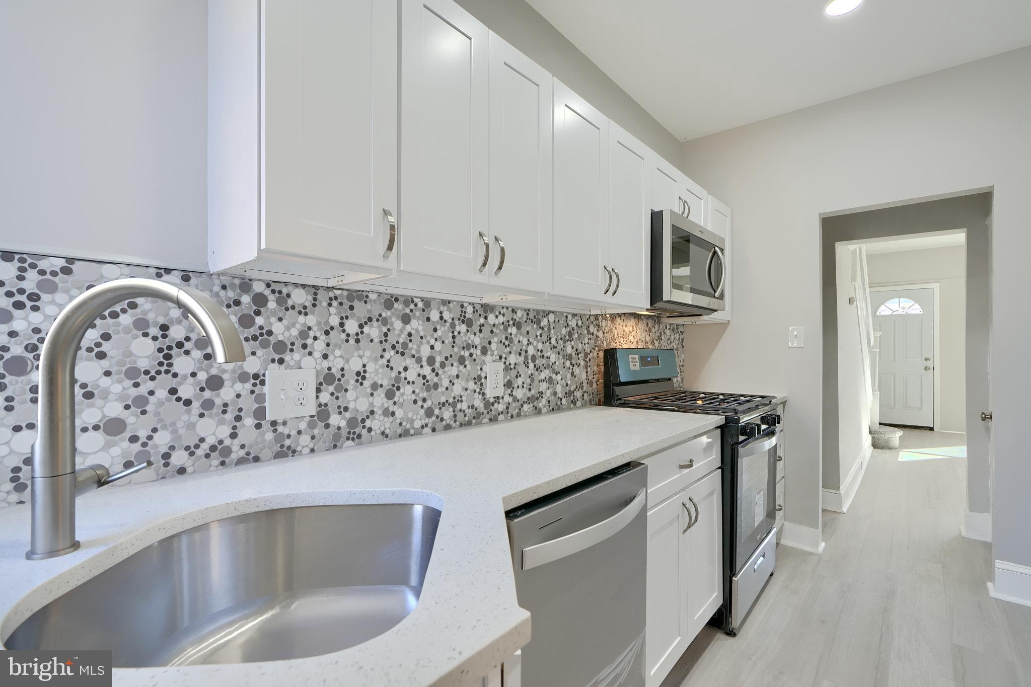 a kitchen with a stove and a white cabinets