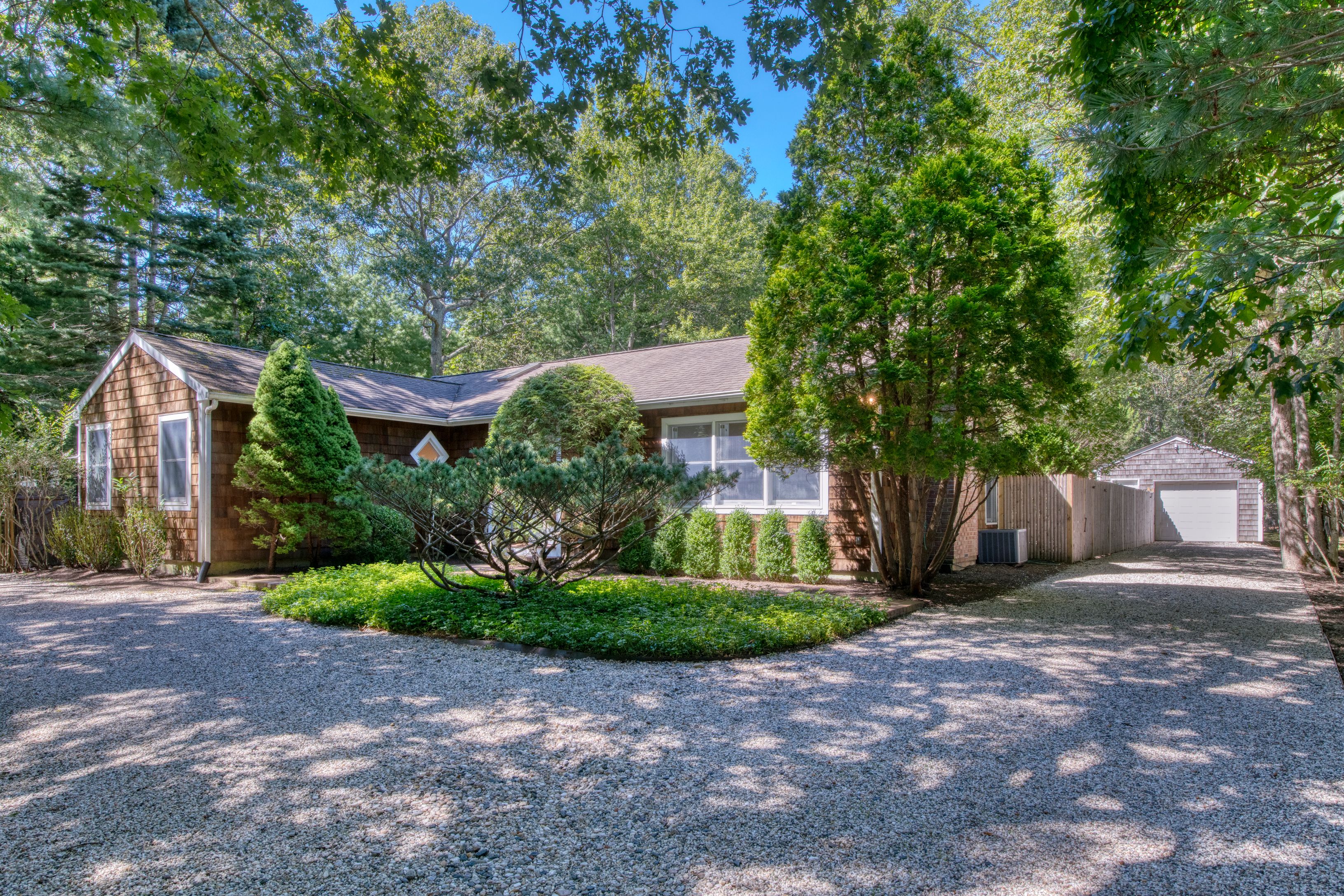 a front view of a house with a yard and a garage