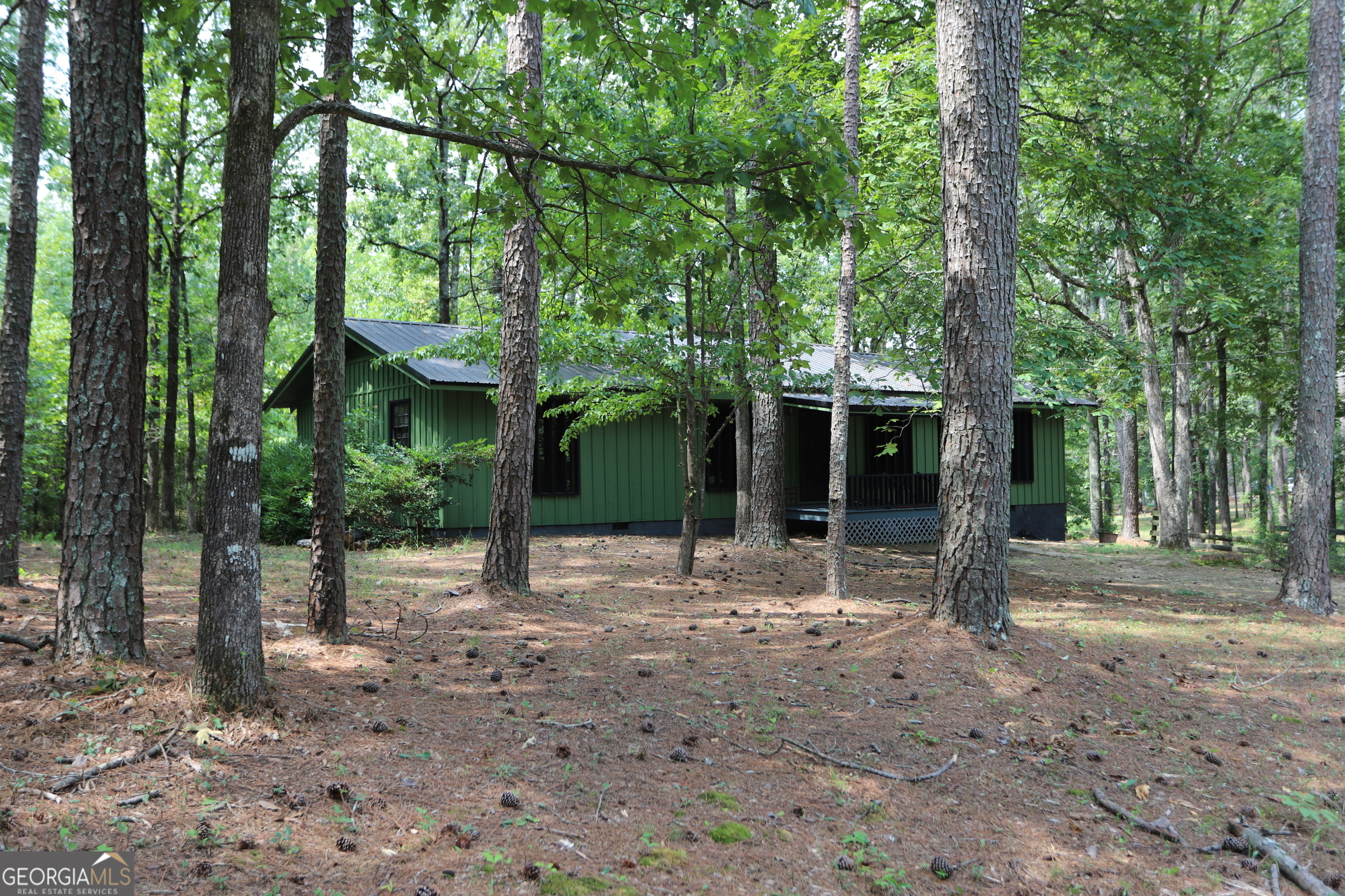 a view of a house with backyard that has a tree