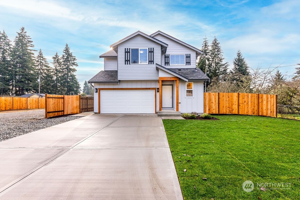 a front view of a house with a yard and garage