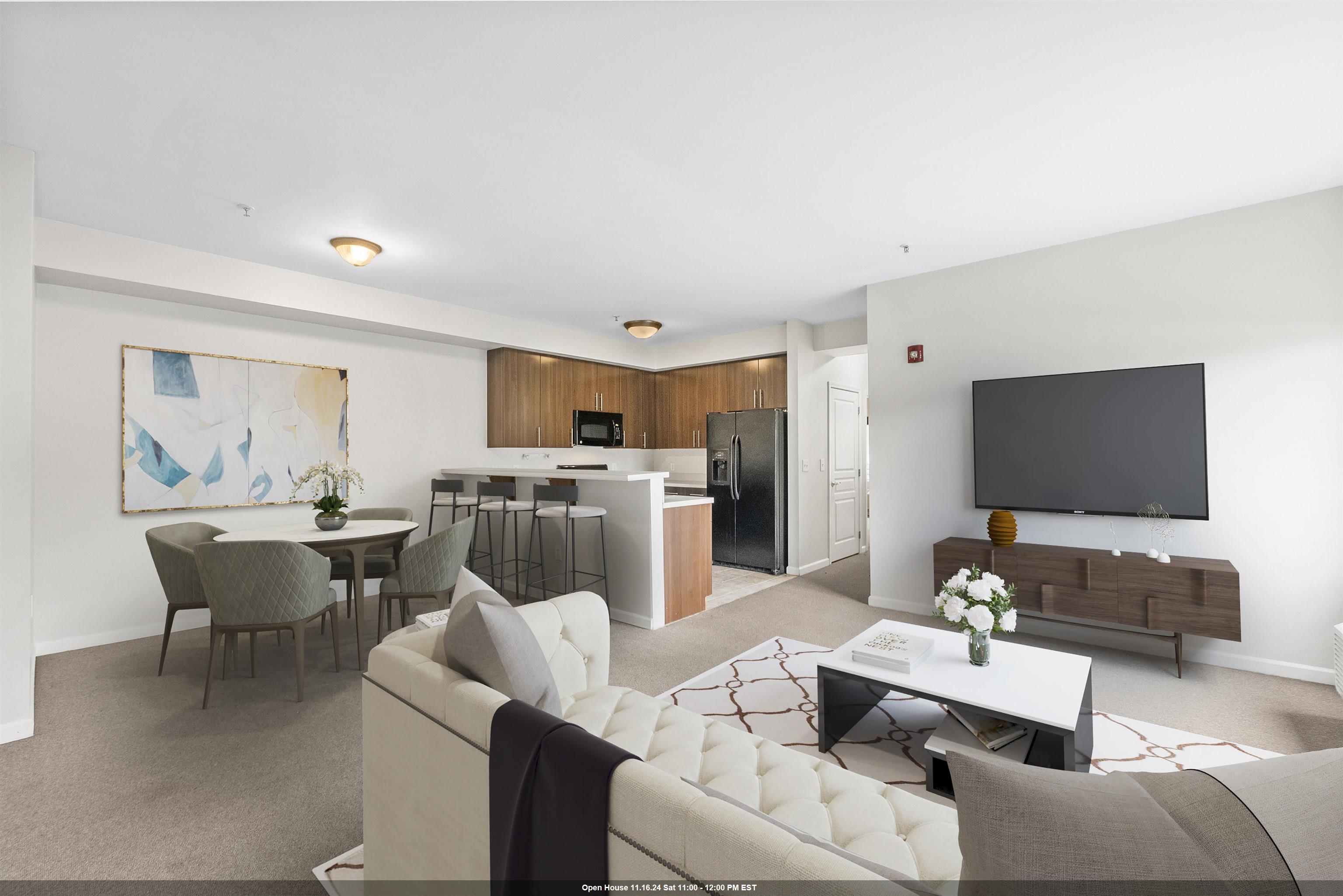 a living room with furniture a rug and a flat screen tv