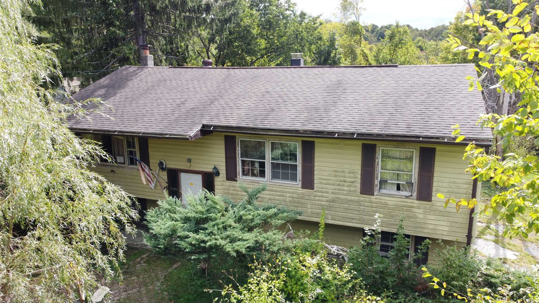 a aerial view of a house with a yard and potted plants