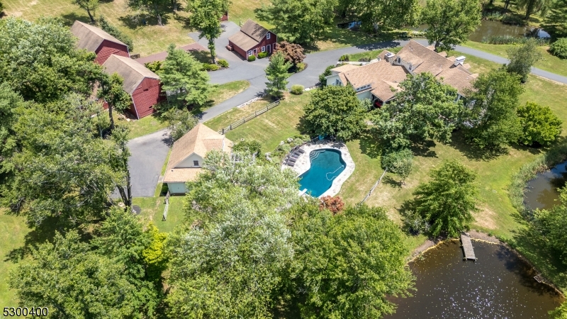 an aerial view of residential house with outdoor space and swimming pool