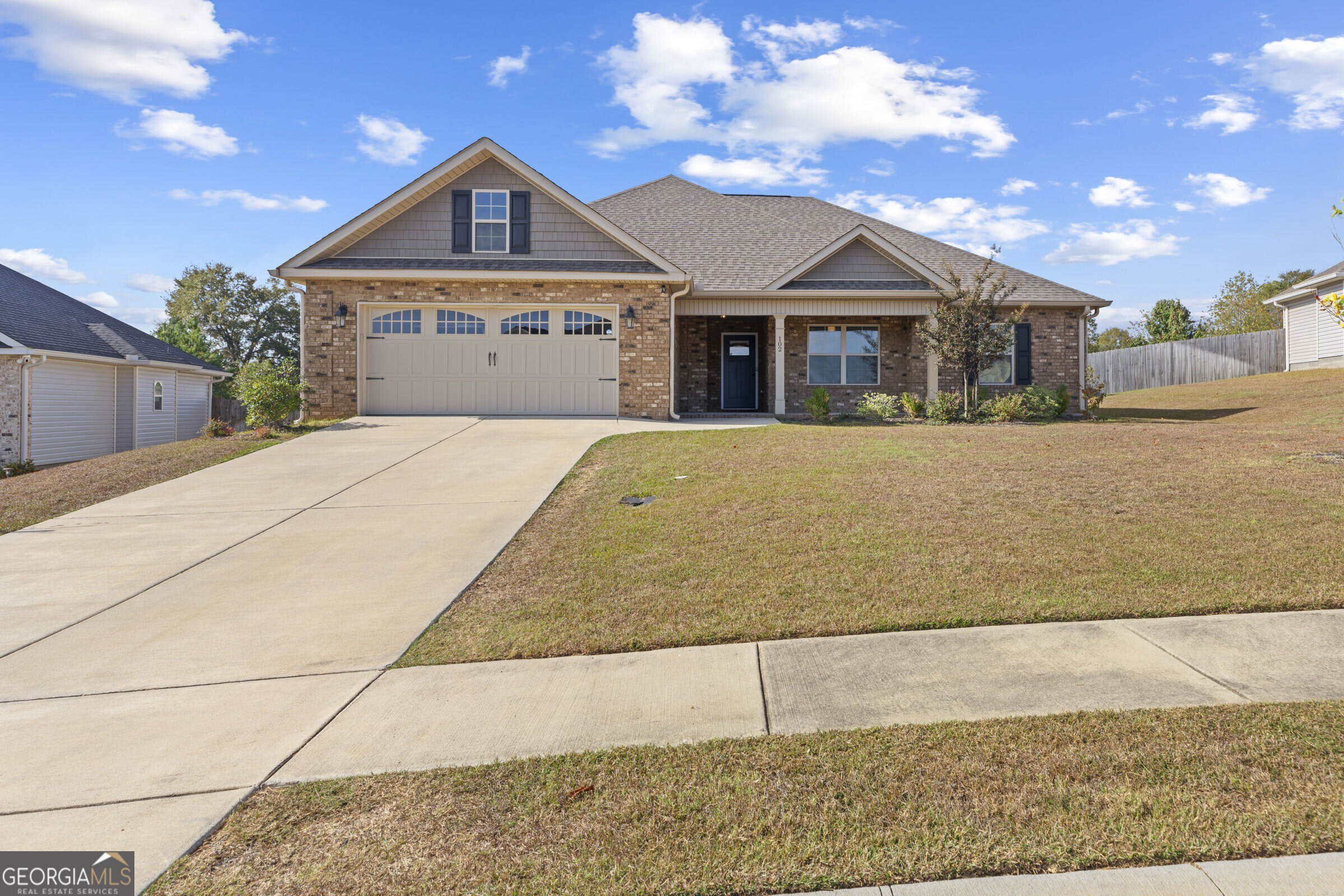 a front view of a house with a yard