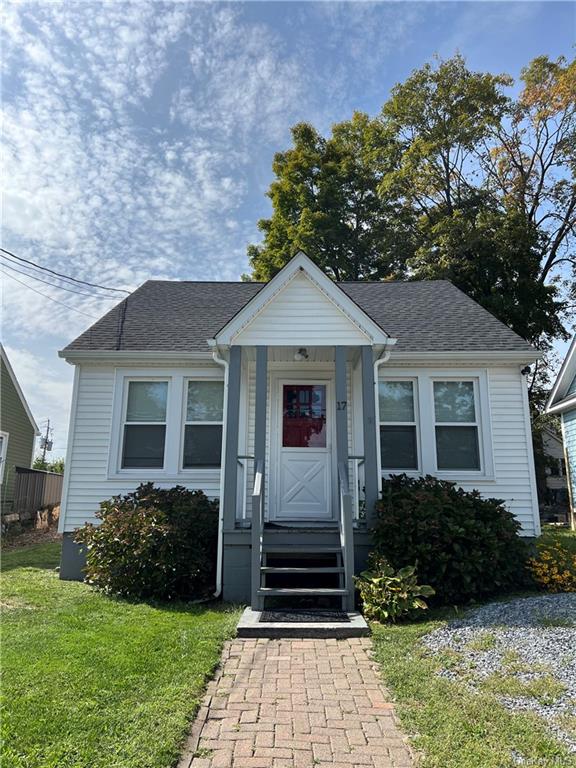 Bungalow-style house with a front lawn