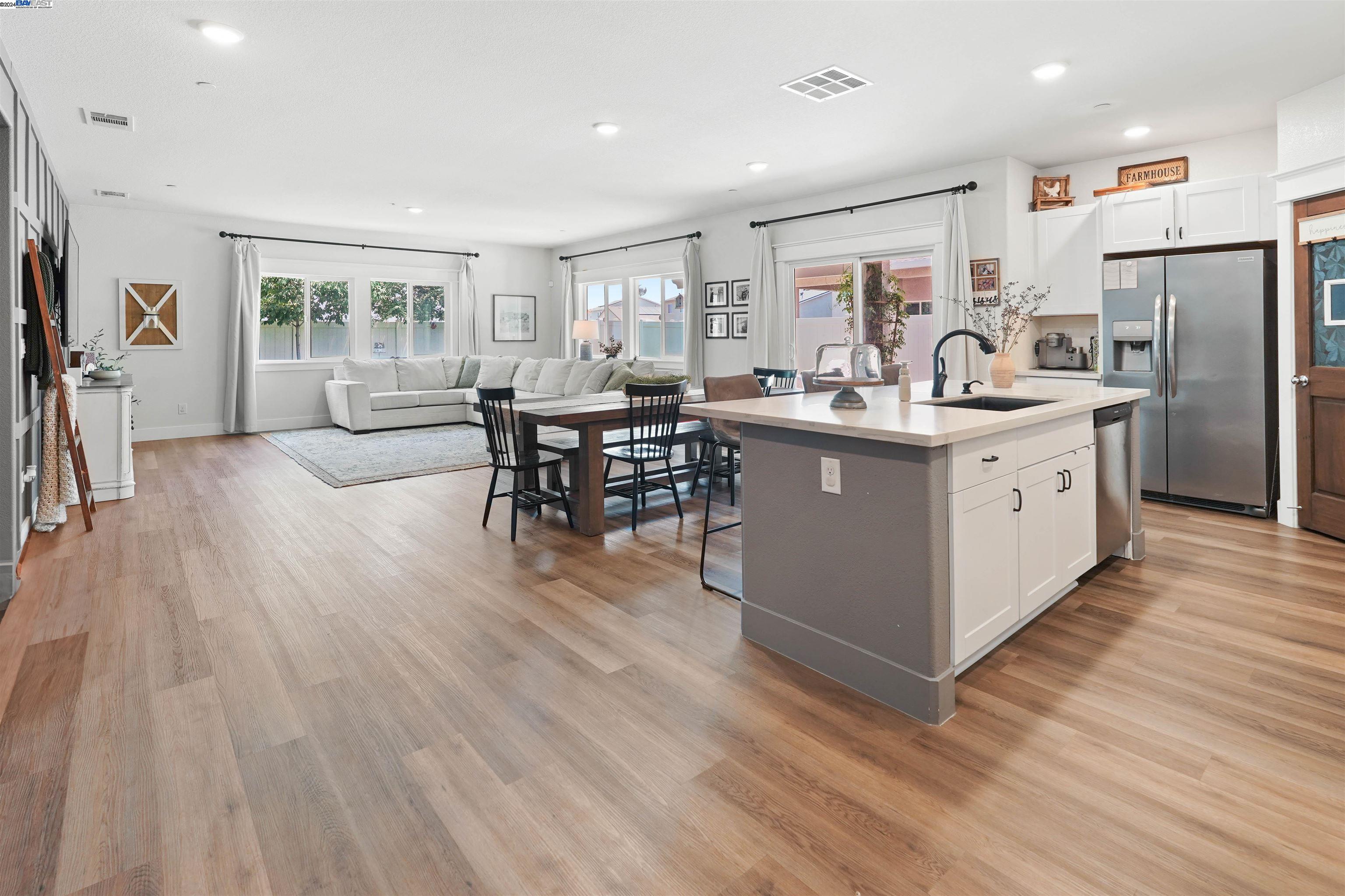 a kitchen with stainless steel appliances granite countertop a lot of counter space and wooden floors