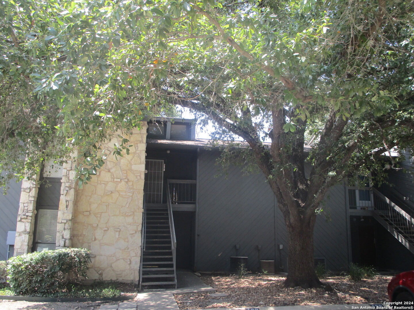 a front view of a house with trees