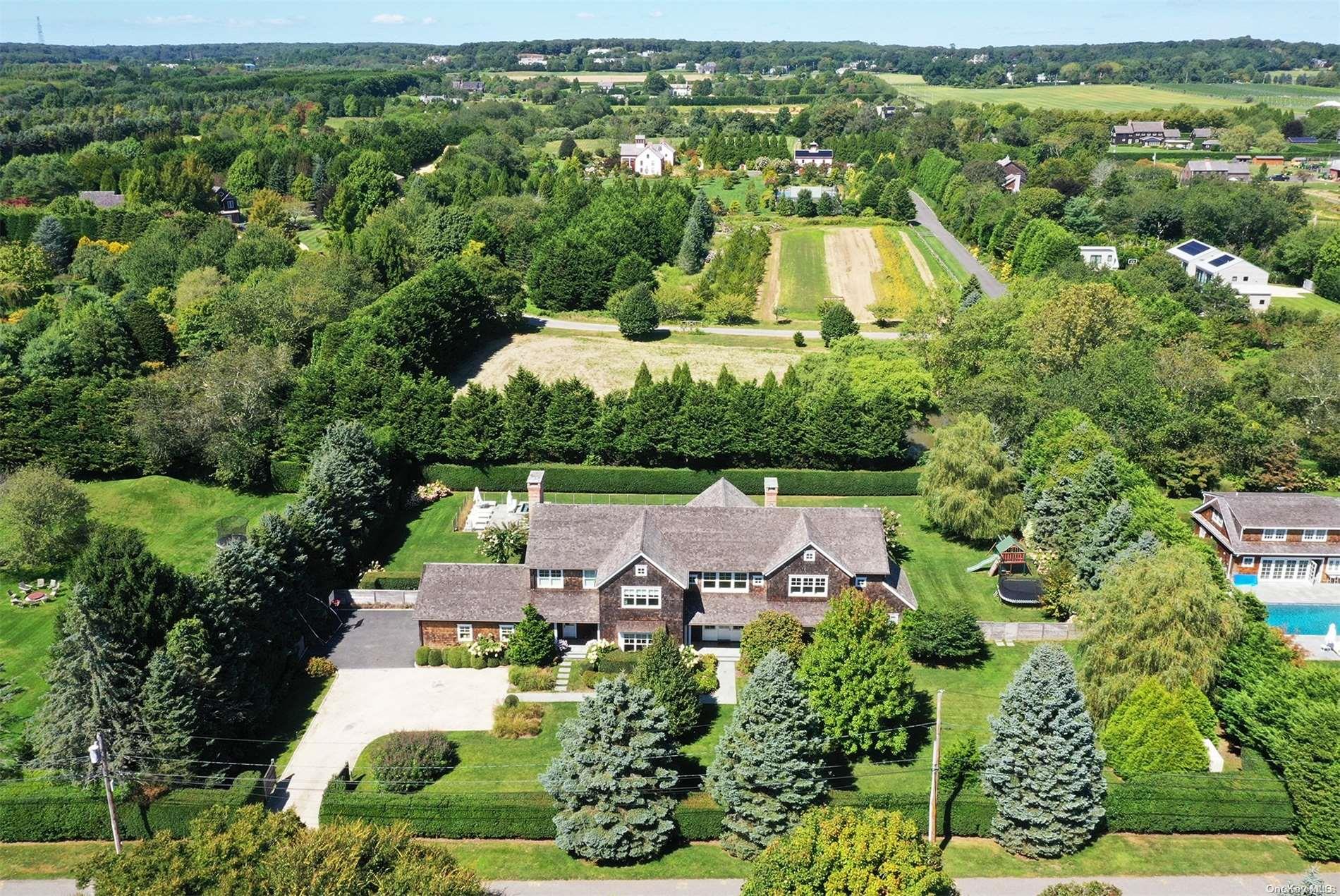 an aerial view of house with yard swimming pool and outdoor seating