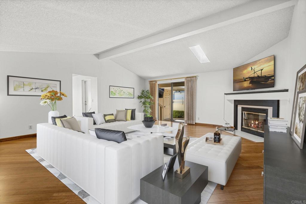 a living room with fireplace furniture and a wooden floor