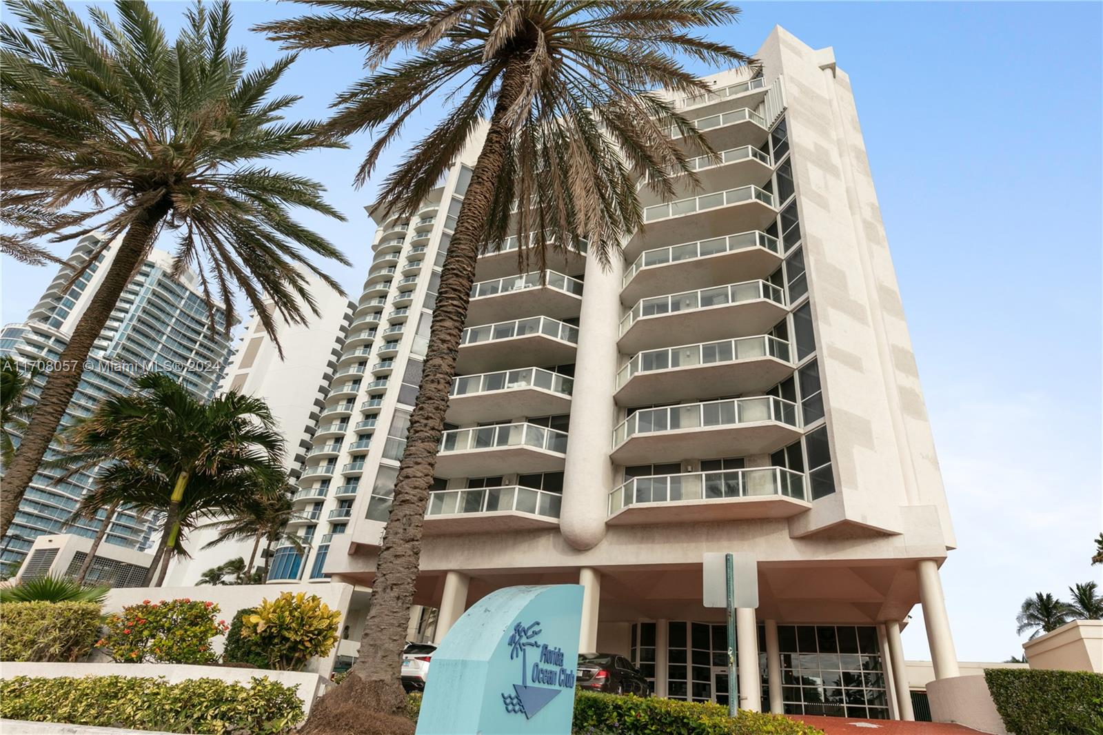 a front view of a multi story residential apartment building with a yard