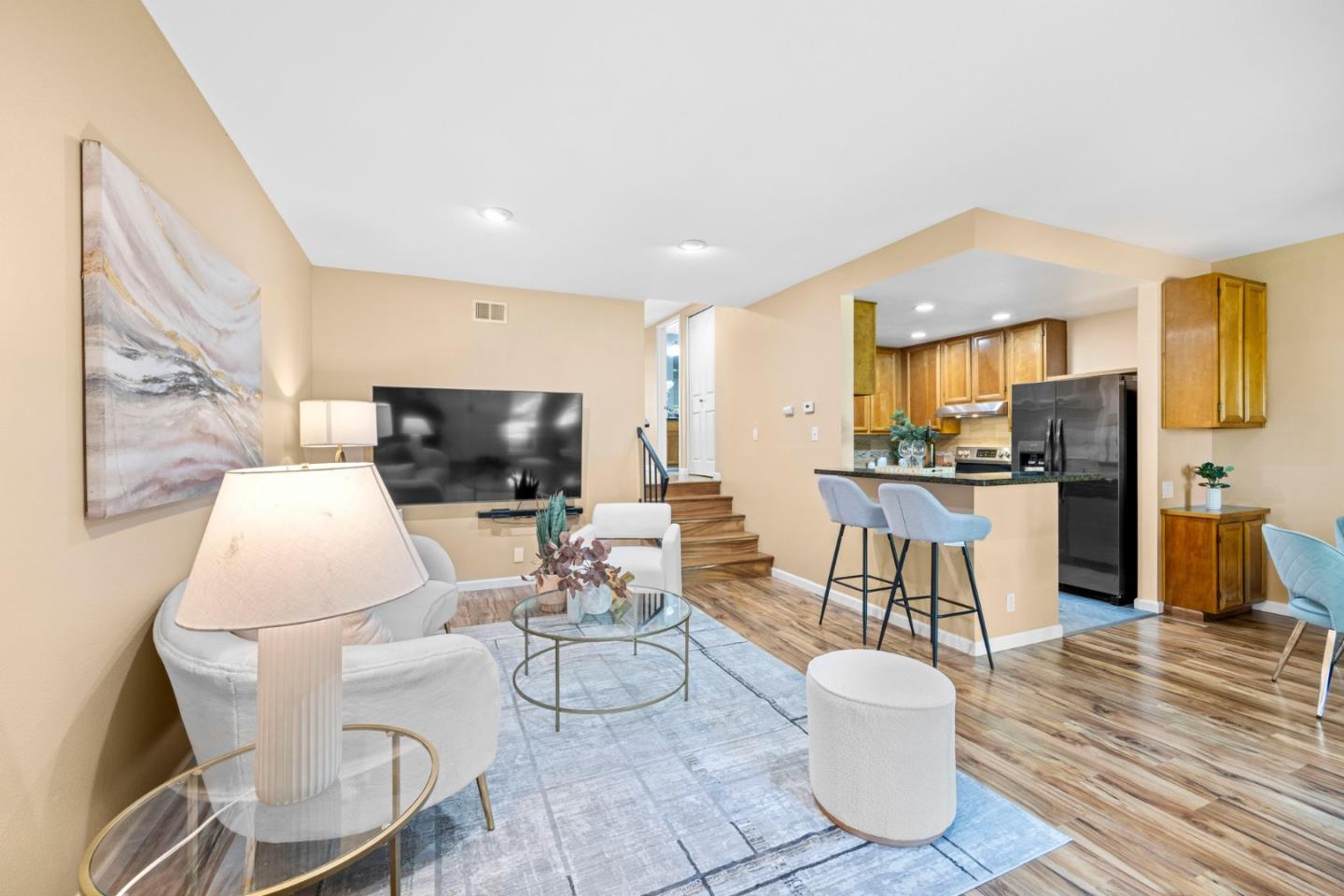 a living room with furniture and kitchen view