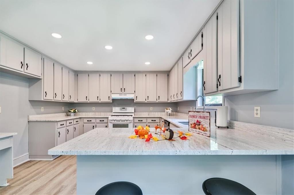 a kitchen with a sink a microwave and cabinets