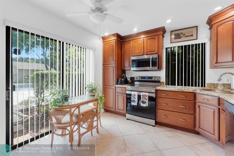 a kitchen with a stove a sink and a refrigerator