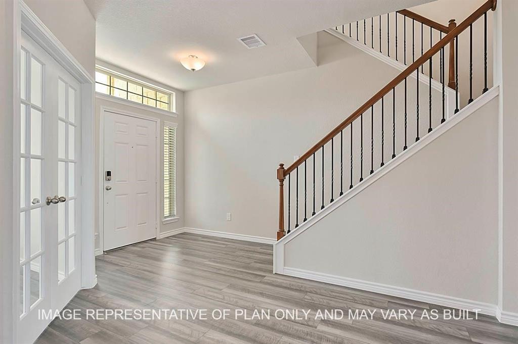 a view of an entryway with wooden floor