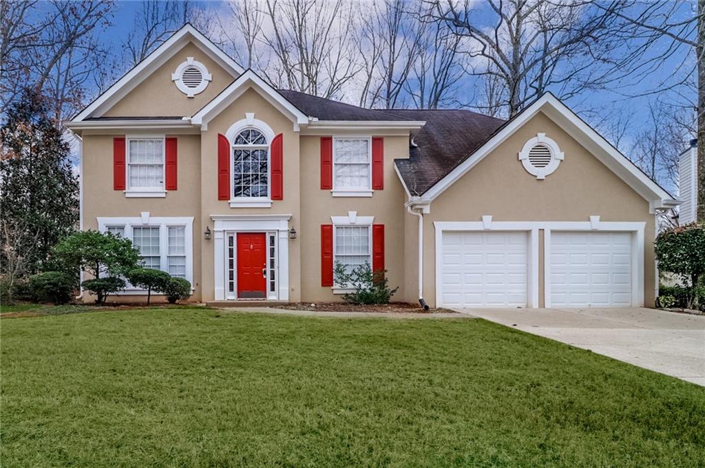 a front view of a house with a yard and garage