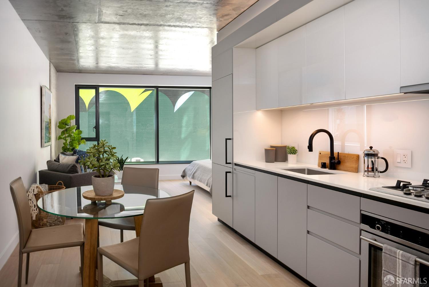 a kitchen with a table chairs and a window