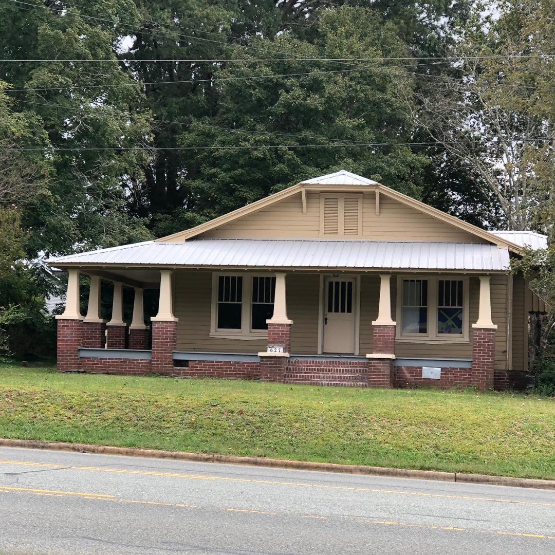 a front view of house with a garden