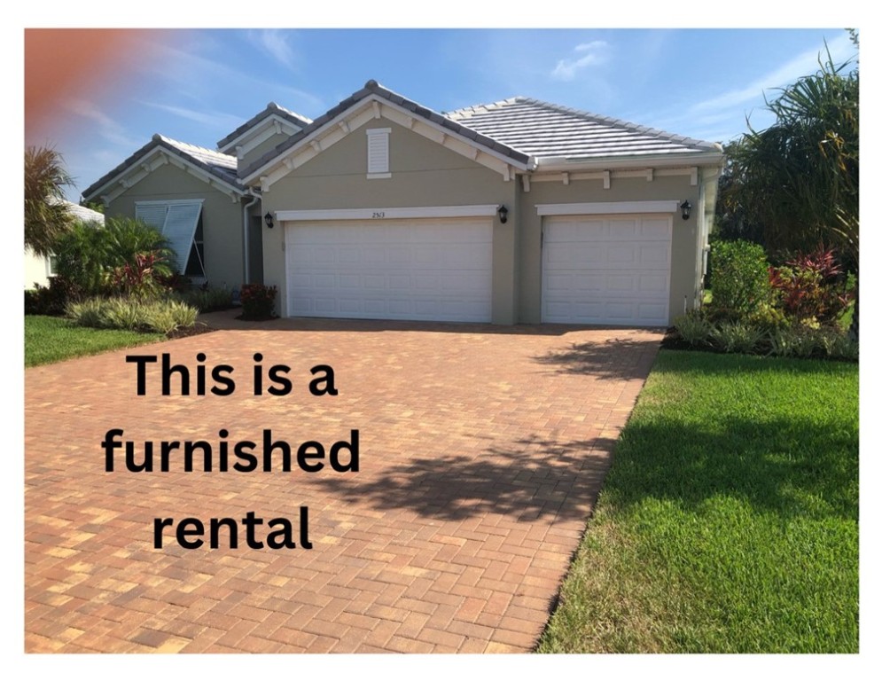 a front of a house with a yard and garage