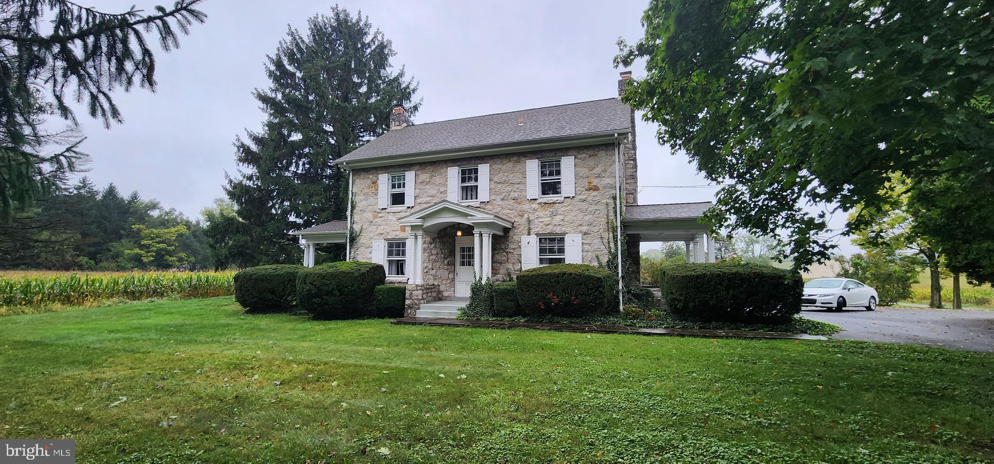 a front view of a house with a yard table and chairs